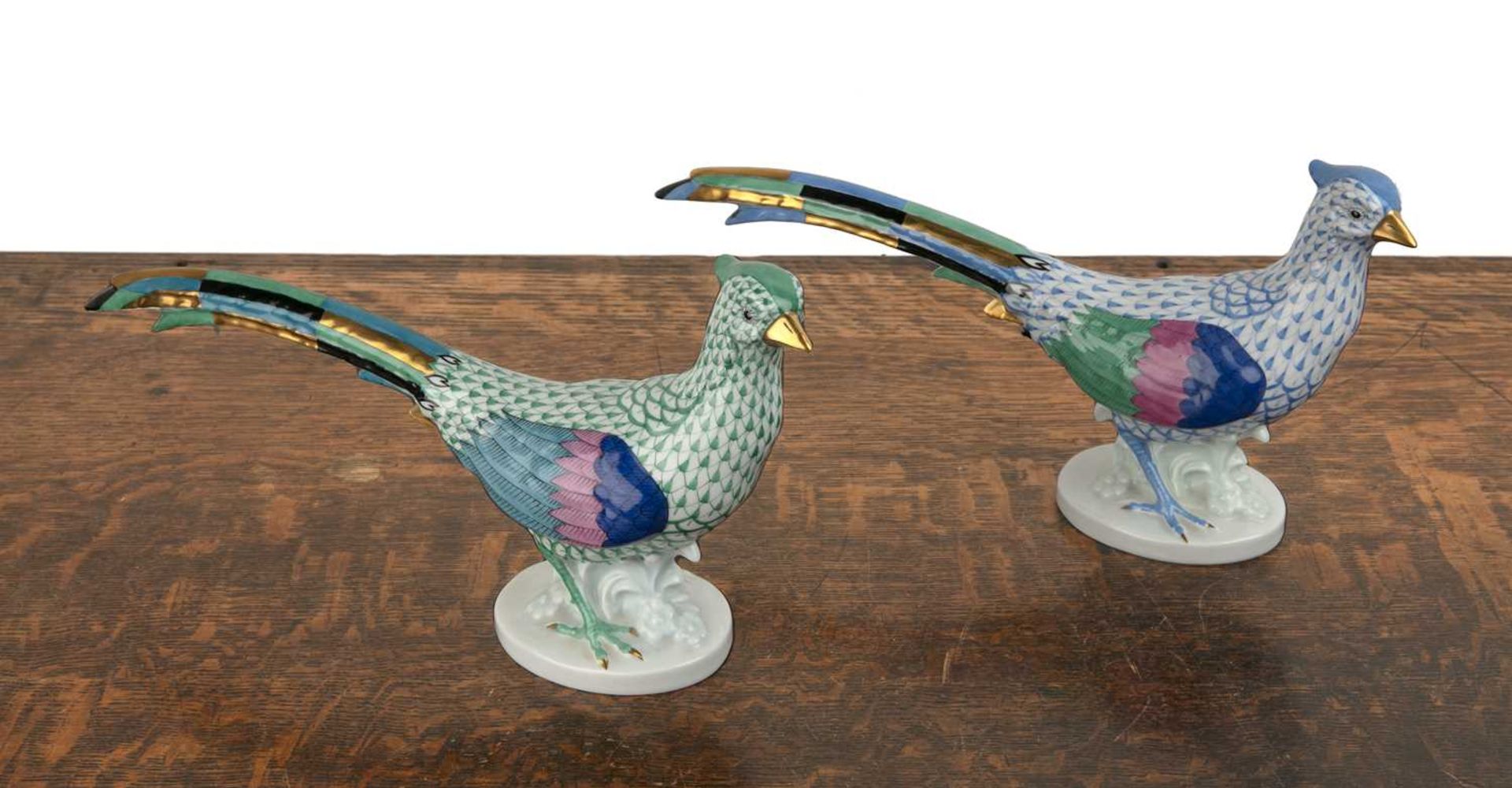 Pair of Herend porcelain pheasants decorated mainly in blue and green, with gilt highlights, printed