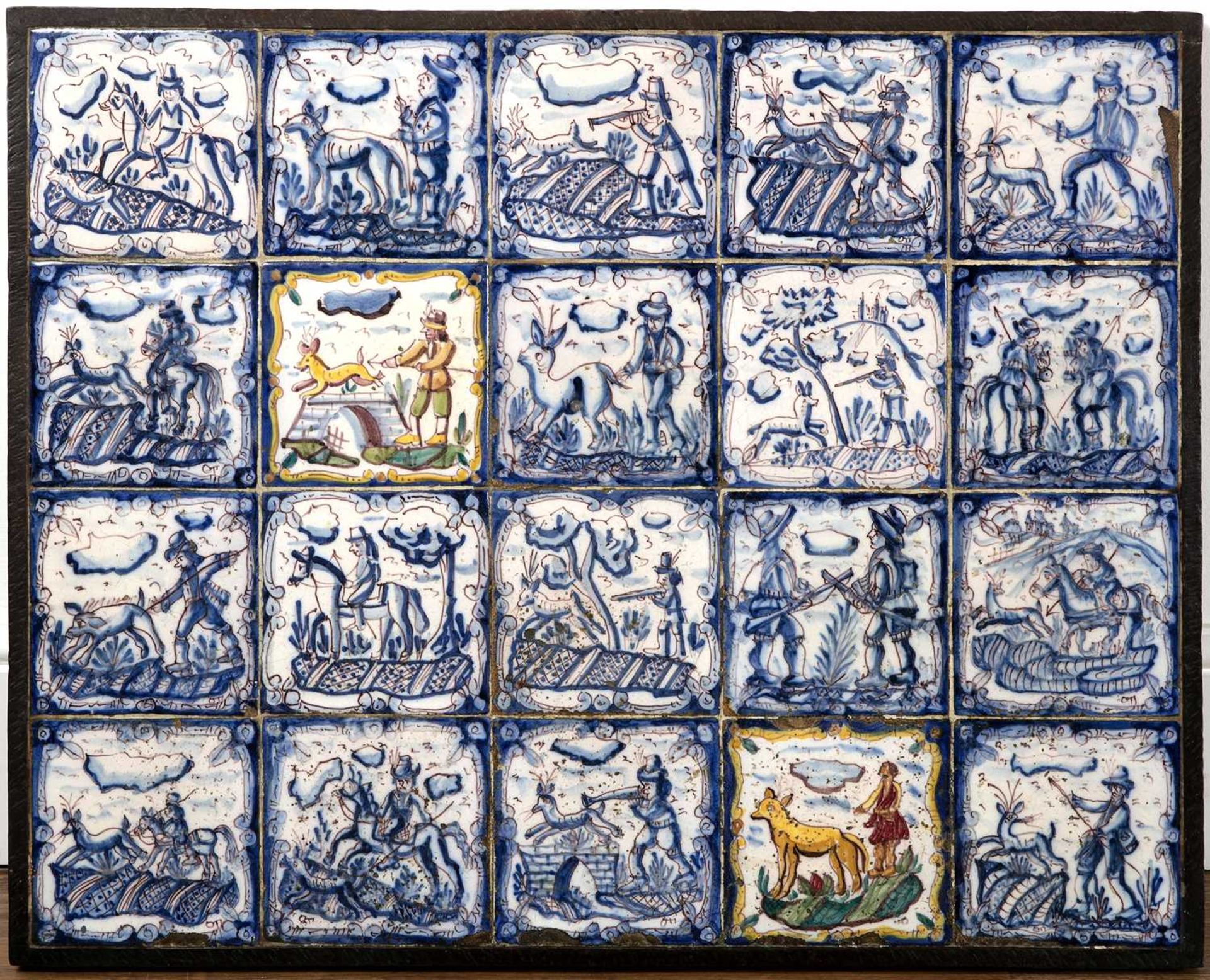 Panel of twenty blue and white and manganese tiles 18th Century, probably Spanish, each painted with