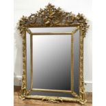 Decorative French gilt framed cushion mirror late 19th Century, bevelled edge mirror plates, with