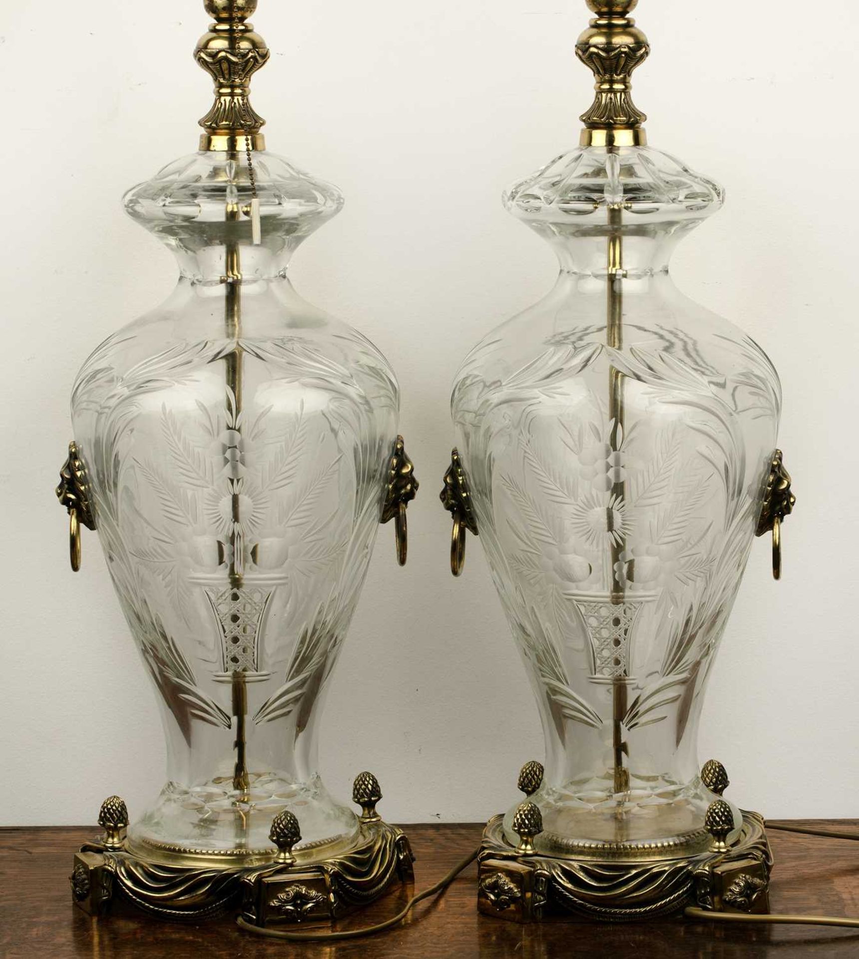 Pair of contemporary etched glass table lamps of baluster form on brass bases, with floral