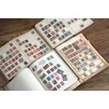 Four stamp albums Simplex Blank Album, Stanley Gibbons Swift Sure, Strand Stamp Album, and a