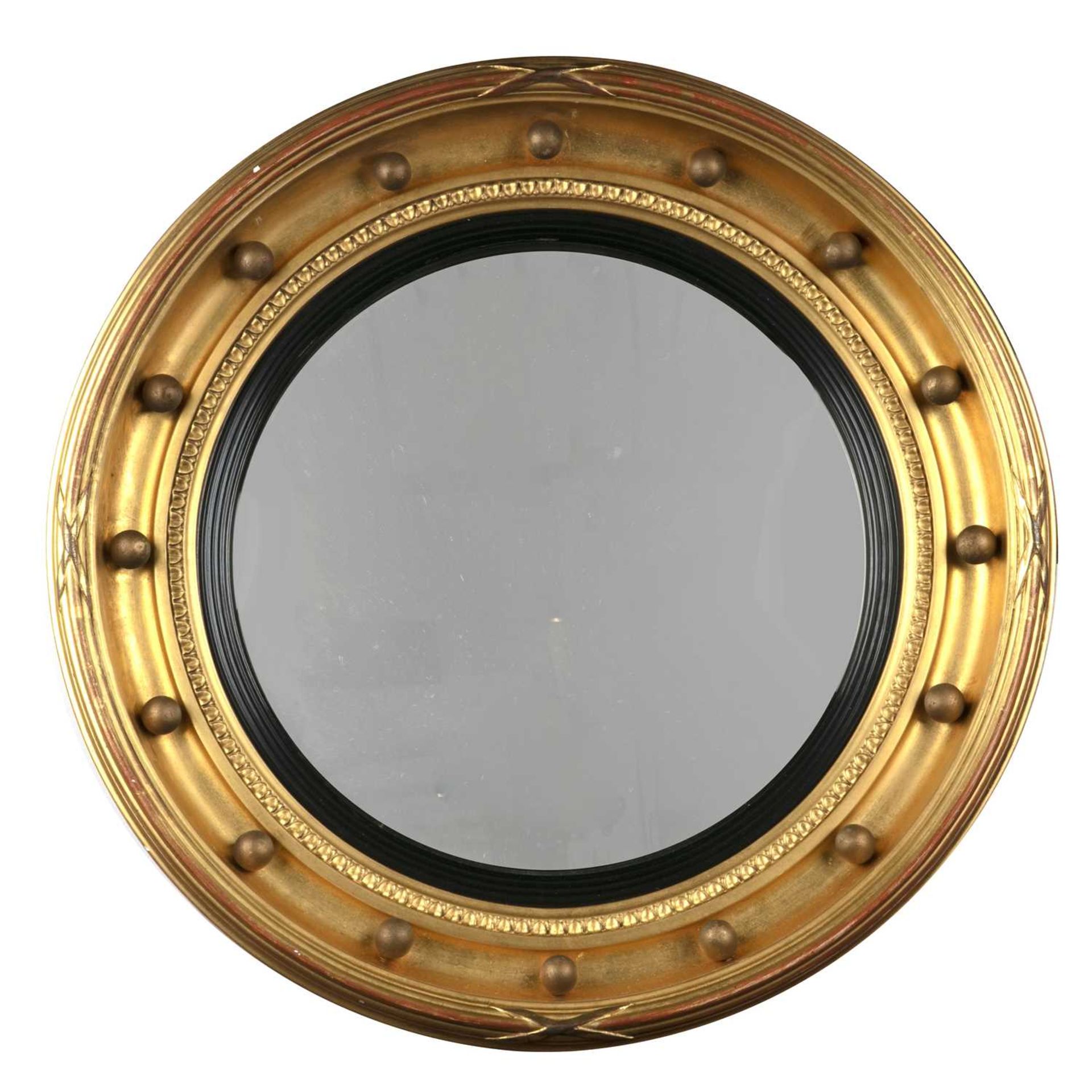 Gilt convex wall mirror 19th Century, with a reeded border and ebonised reeded slip, 57cm