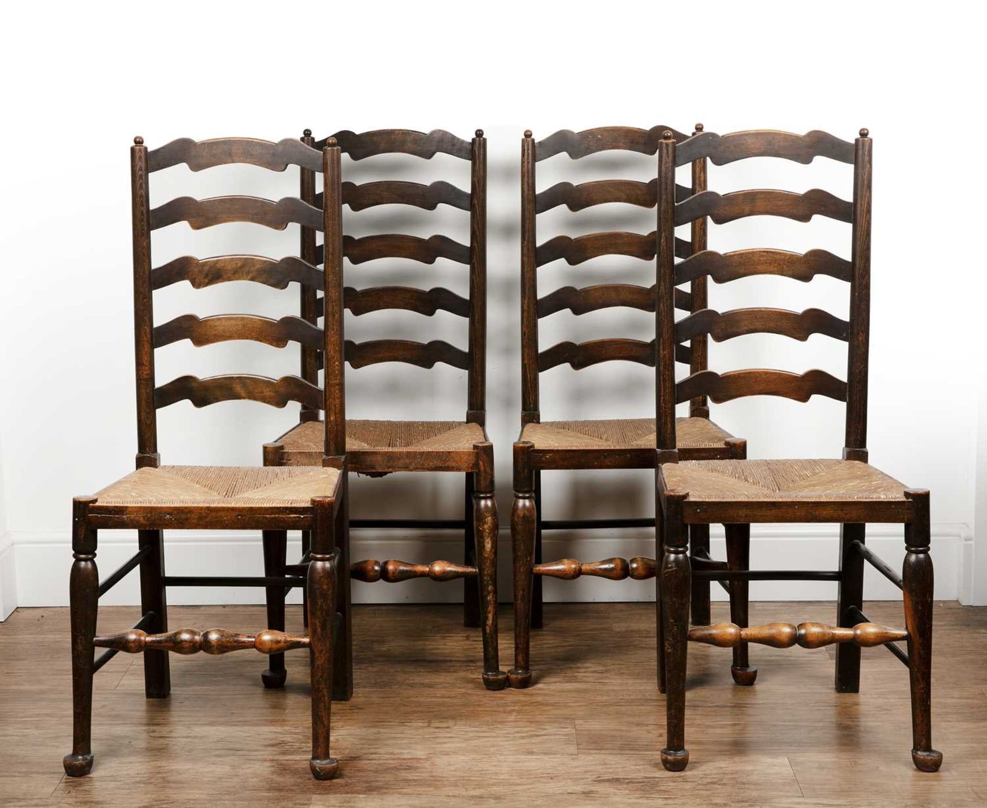 Set of four stained beech ladder back dining chairs with rush seats, 44cm wide x 41cm deep x 105cm