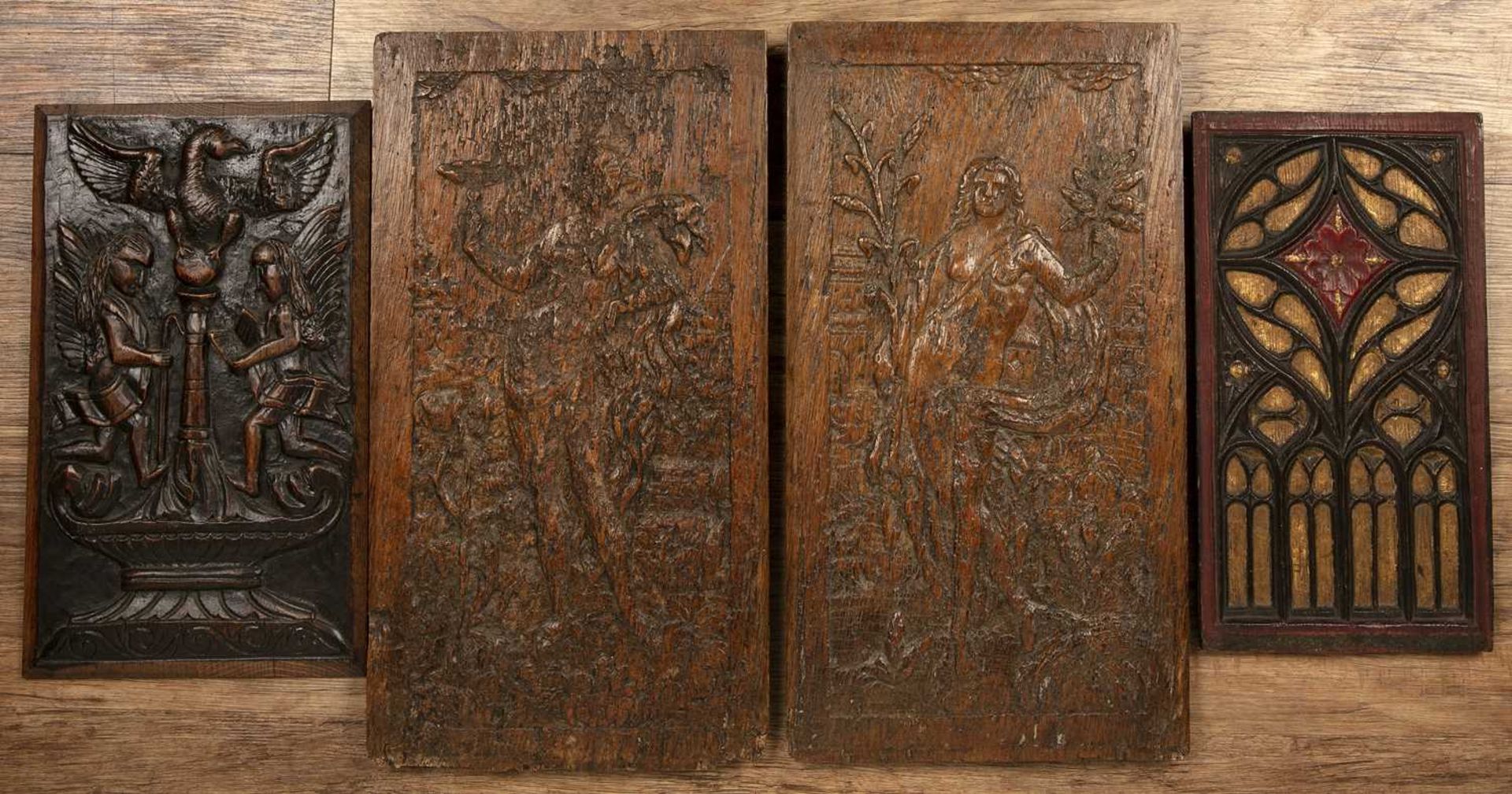 Pair of carved oak panels with carved decoration of figures, 47cm x 25cm and two other carved