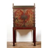 Red lacquered cabinet on stand Chinese, decorated with gilt pagodas, figures, various flowers,