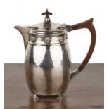 Arts and Crafts silver teapot With beaten effect surface, standing on four feet, bearing marks for