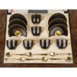 Cased Royal Worcester coffee set Comprising six black and gilt decorated coffee cups and saucers,