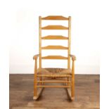 In the manner of Neville Neale Ash and elm, rocking chair with rush seat, unsigned, 109cm high
