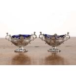 Pair of Victorian silver table salts In the form of urns with blue glass liners, bearing marks for