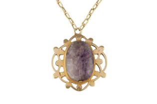 A scarab pendant, the openwork panel centred with a carved amethyst scarab, suspended from a paper-