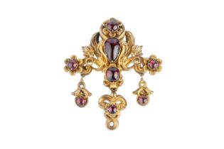 A Victorian garnet panel brooch, designed as a tiered panel of scrolls and flowerheads, accented