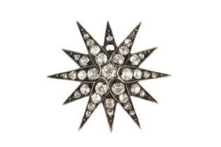 A late Victorian/Edwardian diamond star pendant/brooch, the principal old-cut diamond bordered by