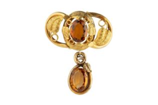 A Victorian citrine panel brooch, the hollow openwork panel centred with an oval mixed-cut