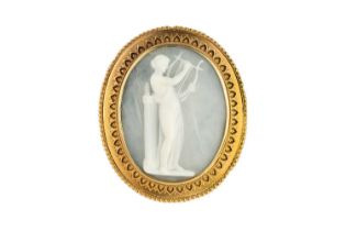 A 19th century cameo brooch, carved to depict a classical female maiden playing the lyre, within a