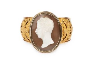 A mid 19th century cameo bangle, the oval shell cameo carved to depict the portrait profile of a