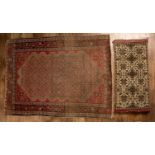 Red ground rug with a shaped central panel, approximately 141.5cm long x 108cm wide, together with