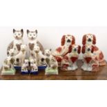 Group of Staffordshire pottery cats and dogs to include a pair of tabby cats, seated on mint green