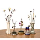 Collection of hatpins and stands to include Charles Horner examples, a velvet silver mounted
