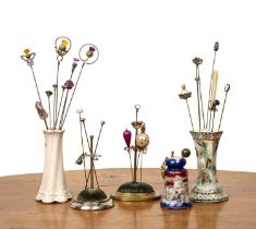 Collection of hatpins and stands to include Charles Horner examples, a velvet silver mounted