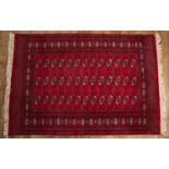 Red ground rug Afghan/Pakistan with elephant foot designs, 126cm x 184cm At present, there is no