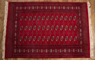 Red ground rug Afghan/Pakistan with elephant foot designs, 126cm x 184cm At present, there is no