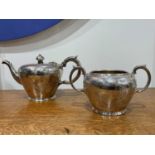 Two piece Victorian silver tea set Consisting of a teapot and a twin handled sucrier, with foliate