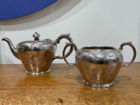 Two piece Victorian silver tea set Consisting of a teapot and a twin handled sucrier, with foliate