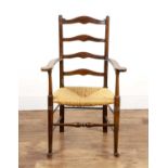 Arts and Crafts style stained beech ladderback armchair with a rush seat, 64cm wide x 103.5cm high
