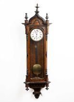 Vienna regulator wall clock in a walnut Gothic style case, having an enamel dial and weight, overall