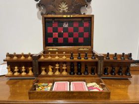 Oak games compendium box with brass details, the compendium opening to reveal a leather chess