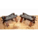 Pair of Benares camel stools Indian, with brass inlay and leather seats, 62cm long With some wear,