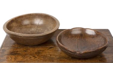 Two treen bowls the smaller example turned oak, 34cm across, the other larger example 40cm across (