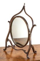 Mahogany dressing mirror with a shaped frame and turned finial, 49cm wide x 73cm high