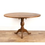 Pitch pine oval kitchen table with a turned column, 122cm x 100cm x 74cm high Provenance: The Olivia