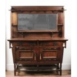 Attributed to Shapland & Petter Arts and Crafts oak sideboard with metal mounts, the mirrored back
