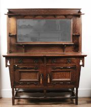 Attributed to Shapland & Petter Arts and Crafts oak sideboard with metal mounts, the mirrored back