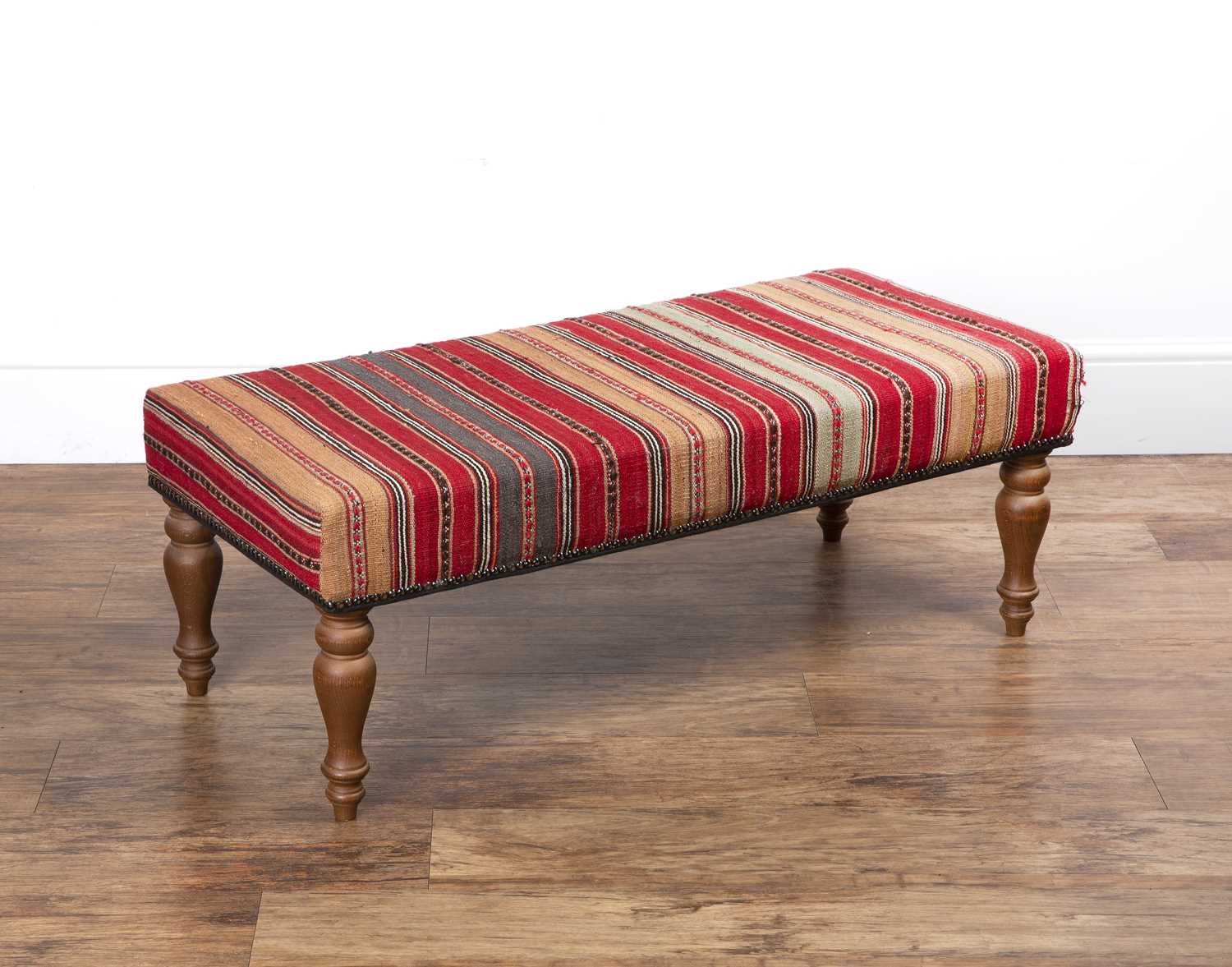 Contemporary footstool with a Kelim type cover, 102cm long x 46cm deep x 38cm high Provenance: The