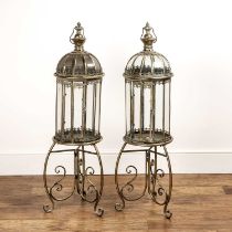 Large pair of brass framed glazed candle lanterns on scrolling feet, with curved handles to the top,