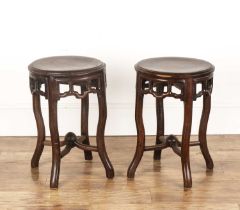 Pair of circular hardwood stands Chinese each with openwork friezes, 35cm diameter x 50.5cm (2) Both