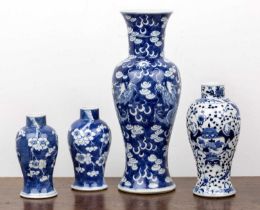 Group of four vases Chinese, 19th Century comprising: a near pair of of blue and white cherry