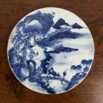 Blue and white porcelain roundel Chinese, 19th Century painted with a lake side scene, 22.5cm