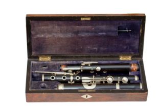 A 19th Century rosewood flute by Keith Prowse and Co London, manufactured in Germany 66cm in