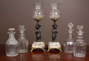 A pair of bronze and glass table lamps together with four cut glass decanters