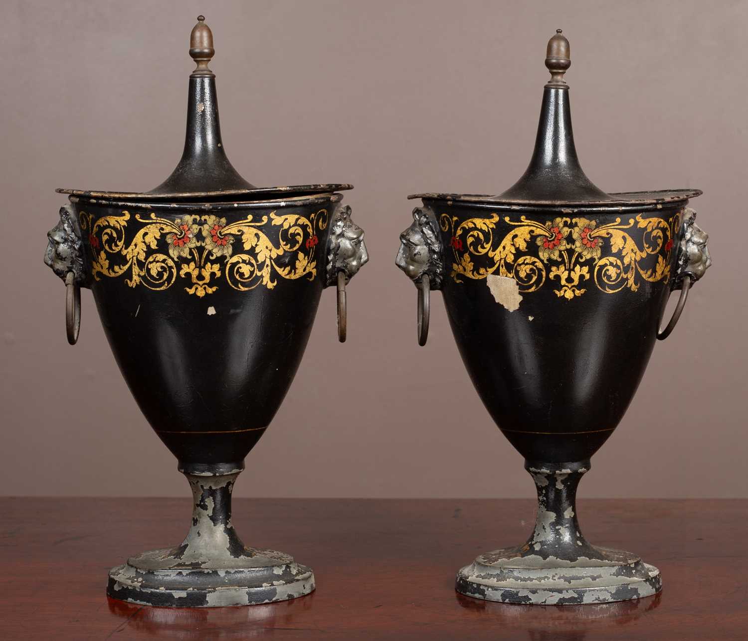 A pair of Regency pedestal toleware chestnut urns