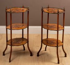 A pair of three tier occasional tables