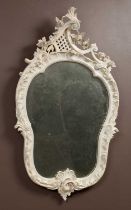 A white painted Rococo style wall mirror 57cm wide x 99cm high Qty: 1 In good condition with some