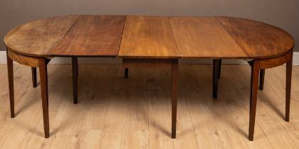 A Regency style mahogany D-end dining table with two leaves, raised on square section tapered legs