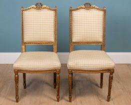 A pair of French gilt carved wood side chairs