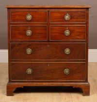 A George III mahogany commode styled as a chest of drawers