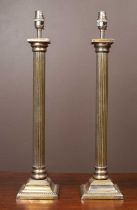 A pair of silver plated brass standard lamps styled as Doric columns